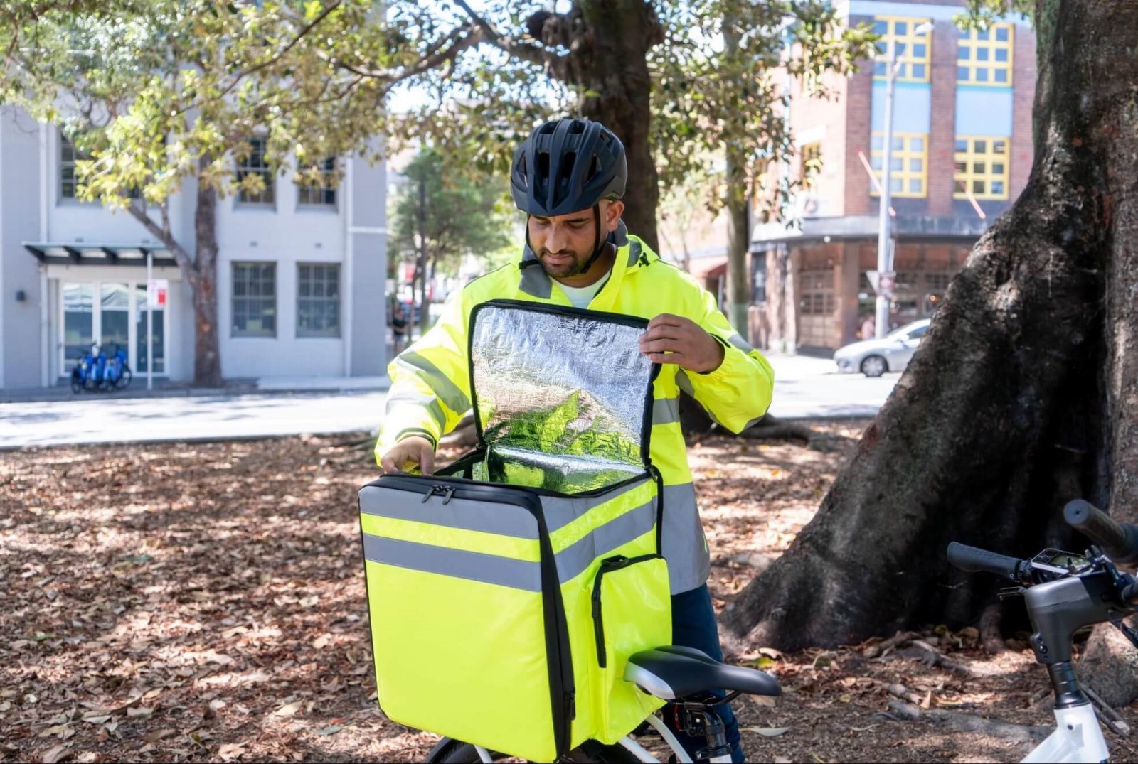 Delivery rider opening an insulated delivery bag